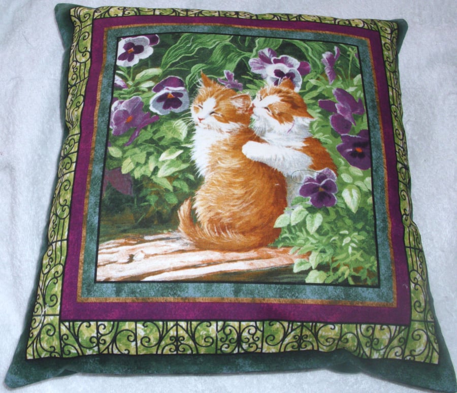 Two pretty ginger and white kitties sitting on a bench cushion 