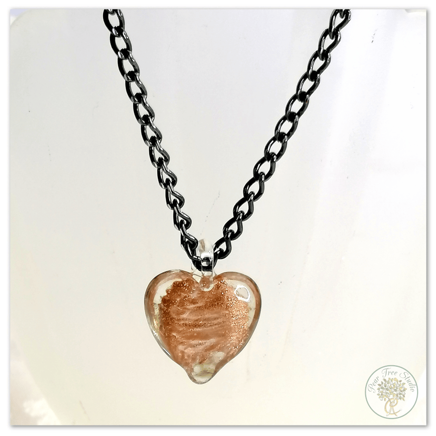 Glass heart pendant with a copper shimmer on black necklace chain