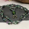 Mala necklace with purple, green and grey gemstones and lampwork bead focal