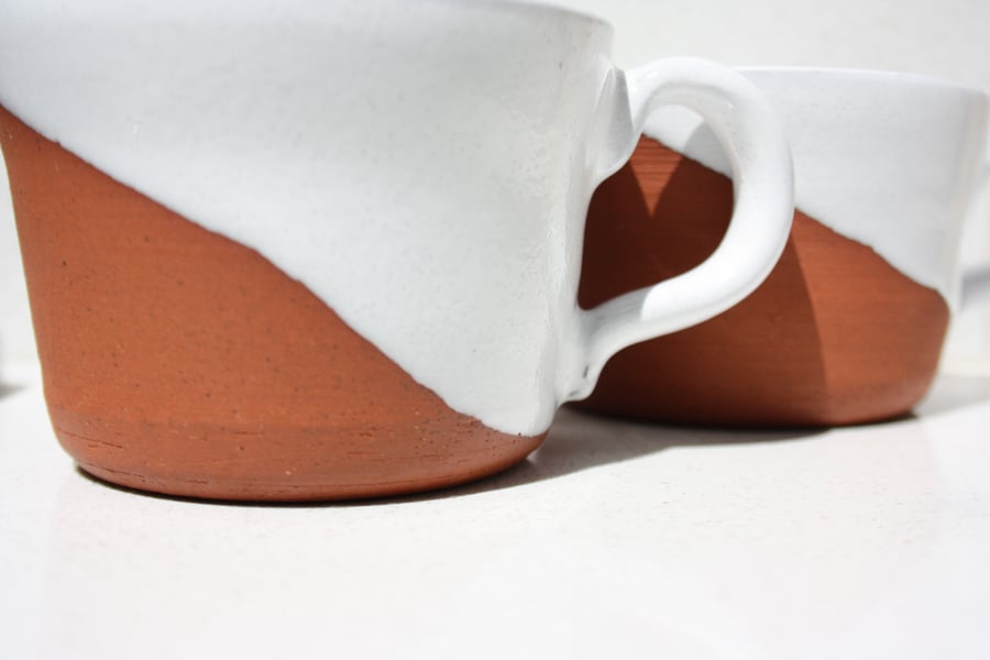 Pair of half-glazed hand-made hand thrown ceramic terracotta coffee cups