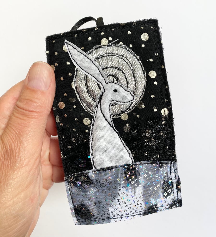Upcycled embroidered hare and moon home decoration. 