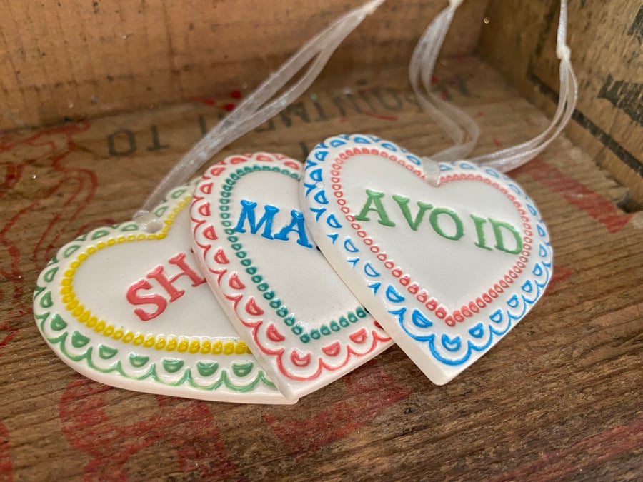 Set of pottery hearts. S, Marry, Avoid. Humour
