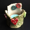 ceramic tea light holder with heart and flower buttons