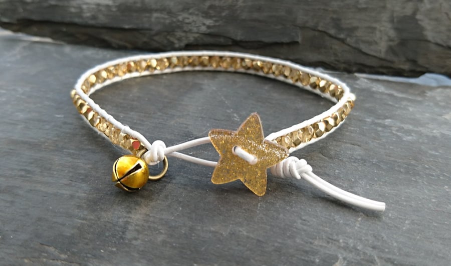 White leather and gold glass bead bracelet with glittery star button and bell
