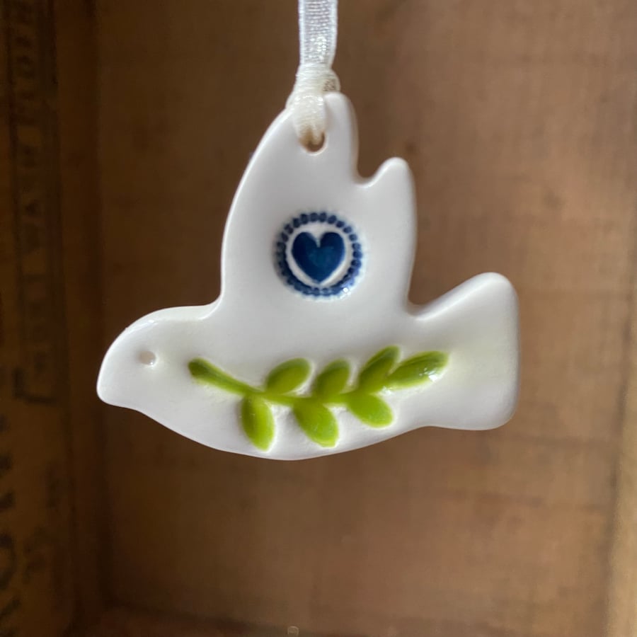 Teeny ceramic dove decoration with leaves and navy blue heart