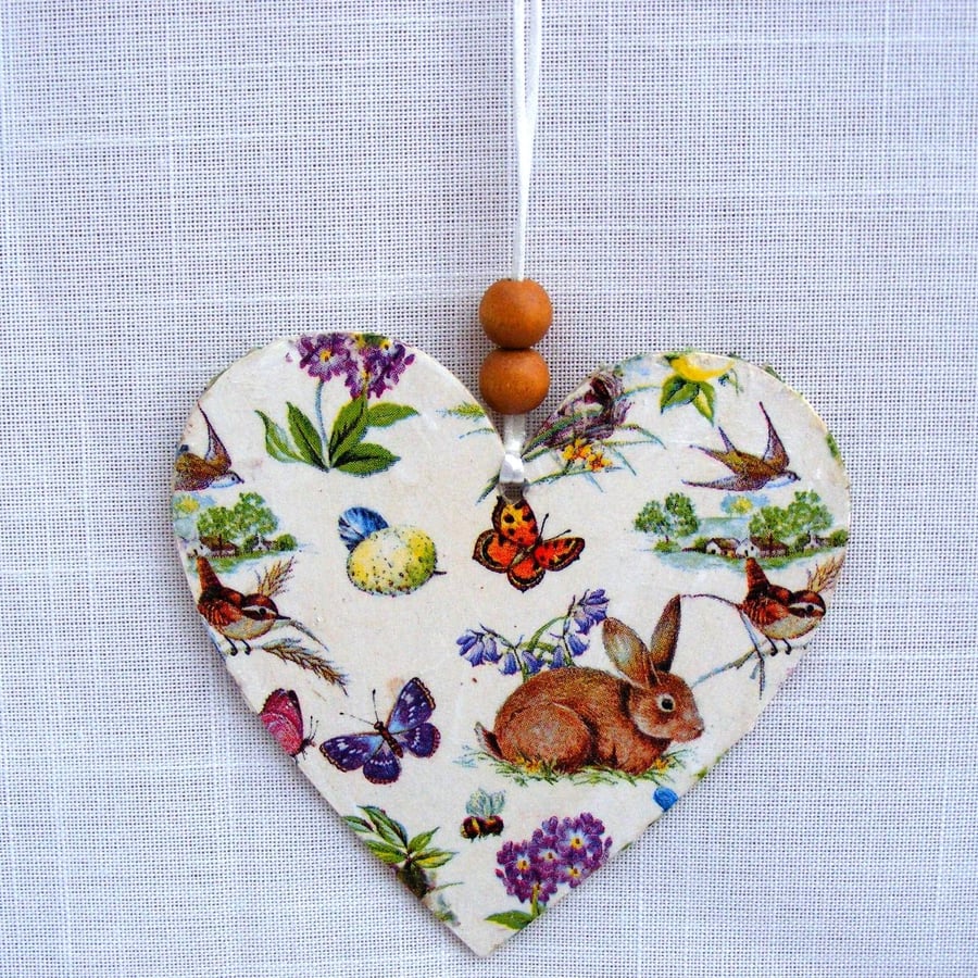 Spring themed decoupaged wooden heart wall decoration.