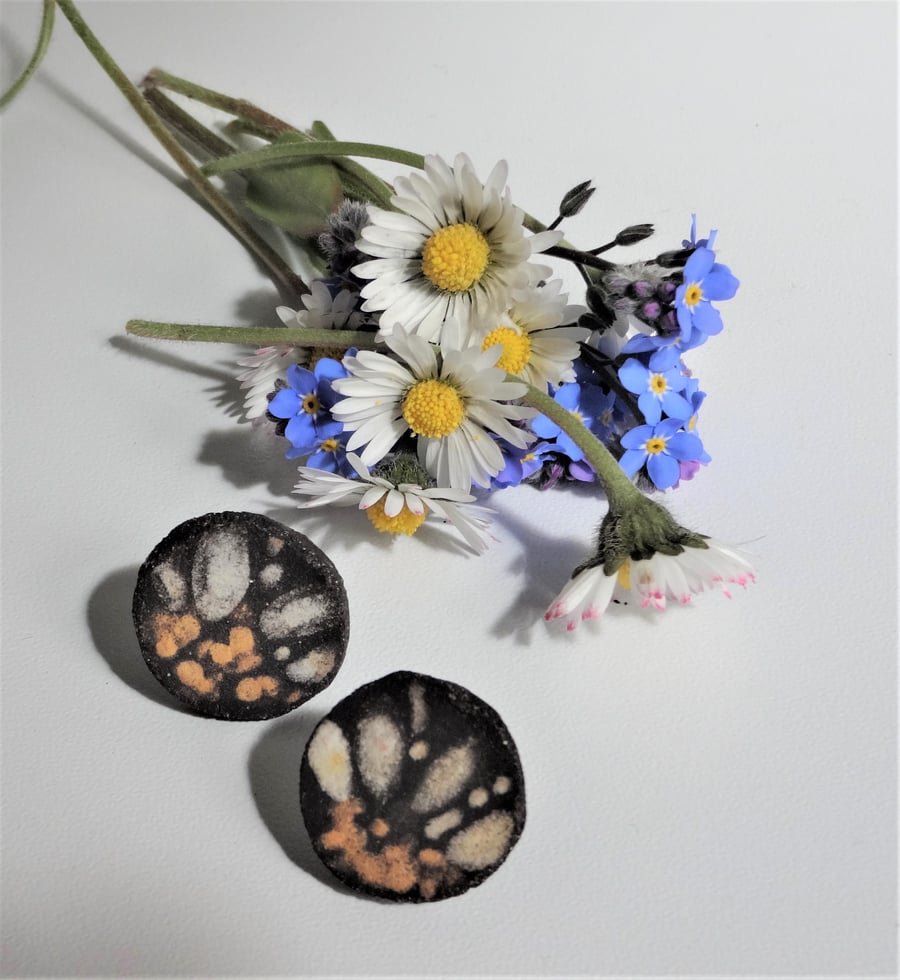Handmade daisy petal ceramic earrings with sterling silver fittings.