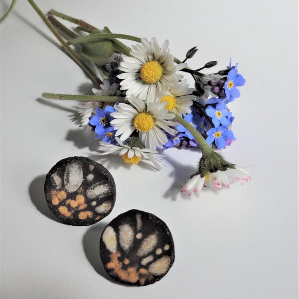 Handmade daisy petal ceramic earrings with sterling silver fittings.