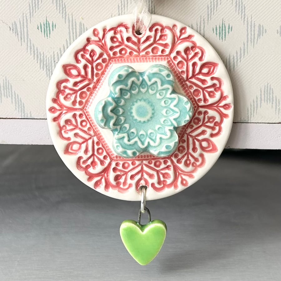 Pottery flower decoration with dangly heart 