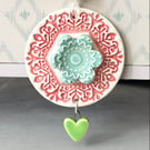 Pottery flower decoration with dangly heart 