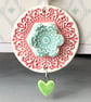 Pottery flower decoration with dangly heart 