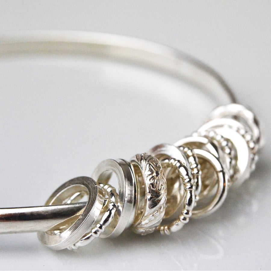 Bangle with ring charms