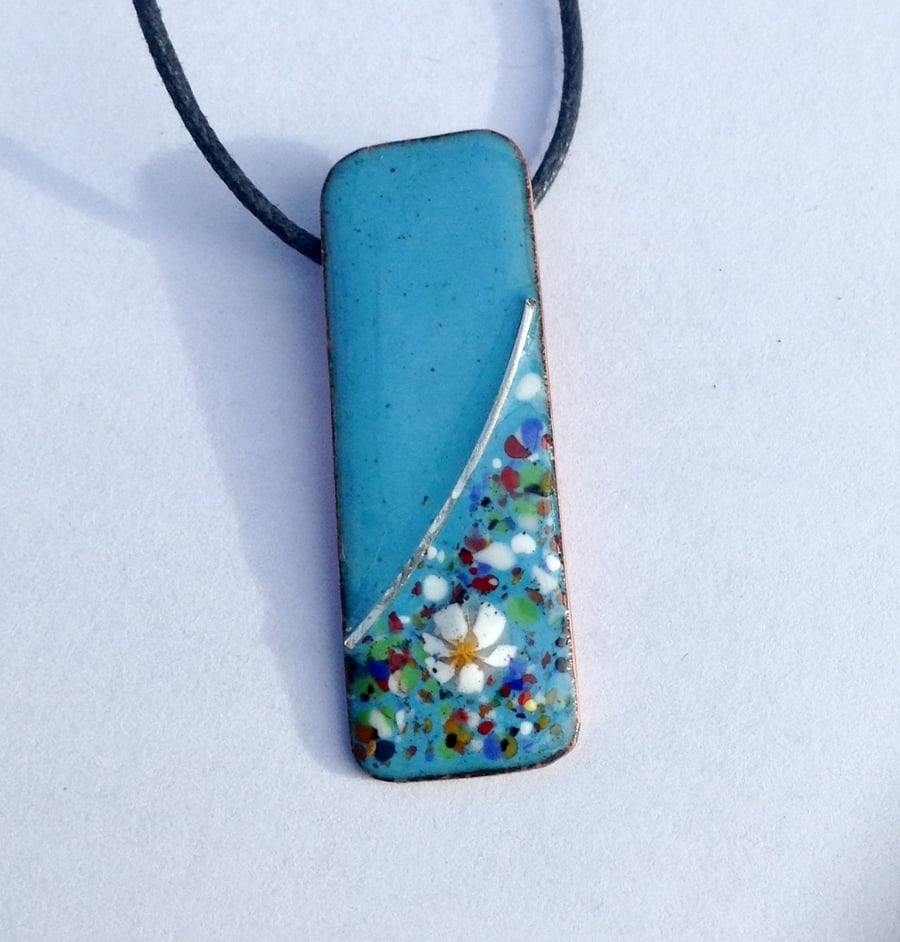SMALL, SLIM, OBLONG FLORAL ENAMELLED PENDANT WITH STERLING SILVER DESIGN