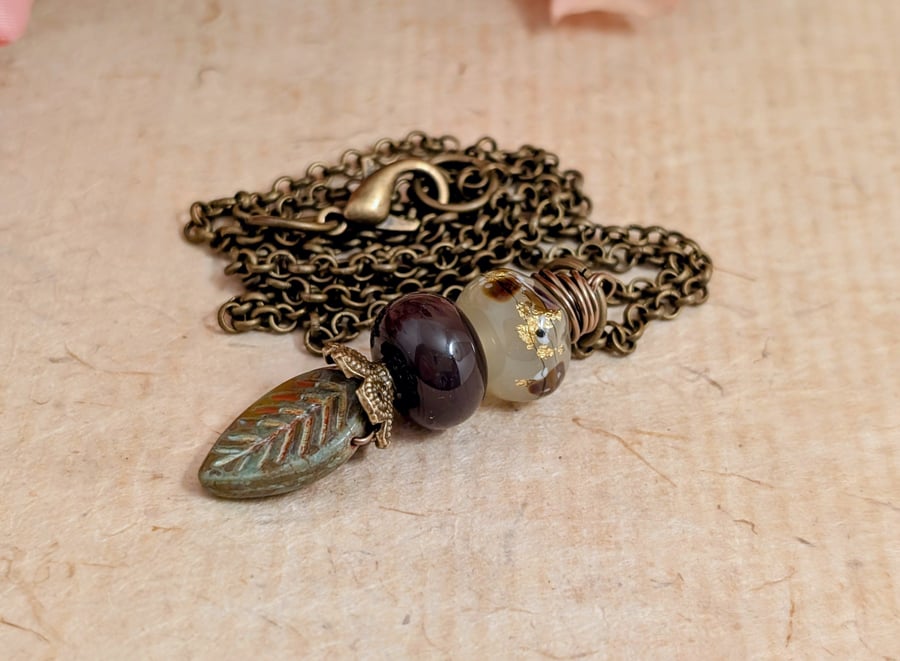 Green glass leaf and maroon and gold beads pendant with antique gold chain 