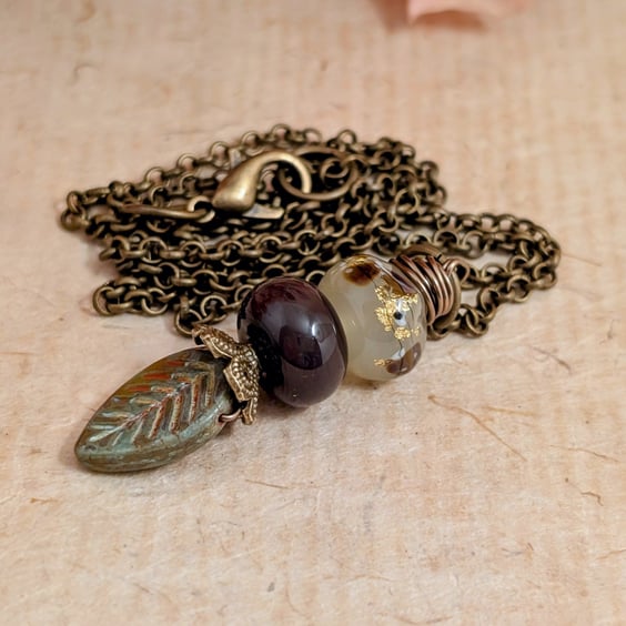 Green glass leaf and maroon and gold beads pendant with antique gold chain 