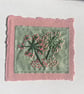Hand embroidered flowers on dark green fabric
