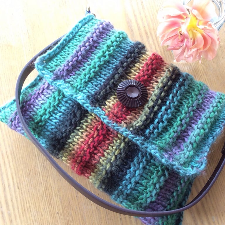 Soft multi coloured little knitted flapped woolly shoulder or clutch bag.