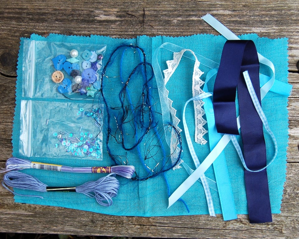 Upcycled slow stitching kit includes fabric, buttons, thread, lace, ribbon