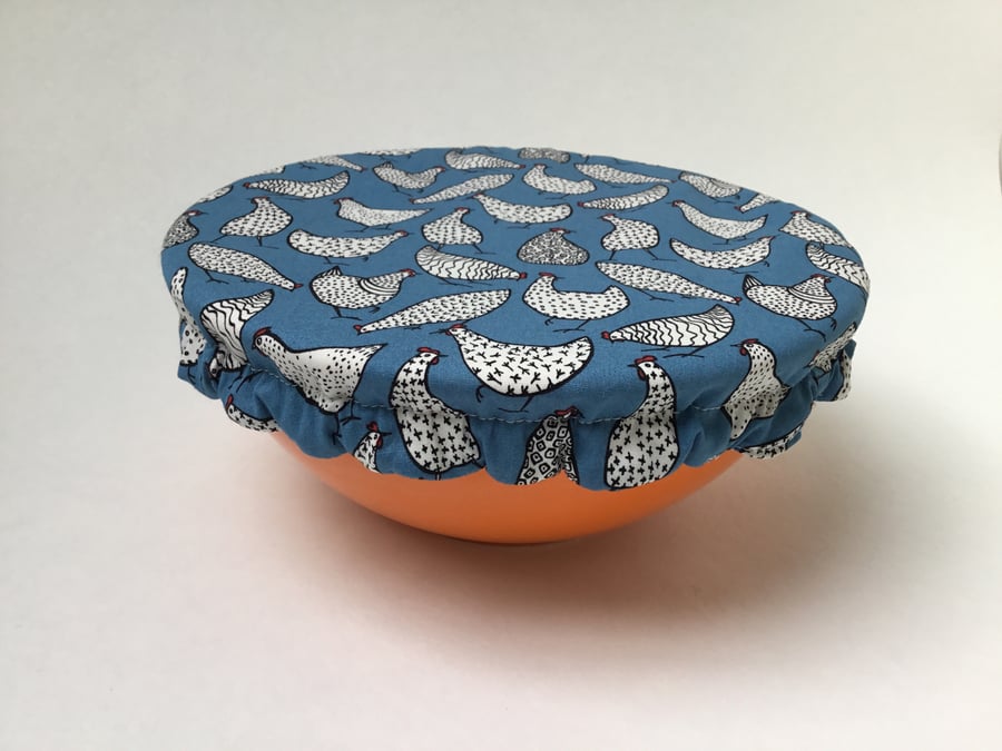 Medium reusable bowl cover to keep food fresh and safe. Blue chickens.