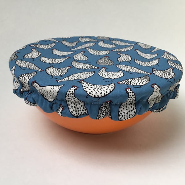 Medium reusable bowl cover to keep food fresh and safe. Blue chickens.