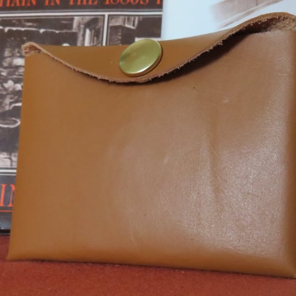 Light brown key case which can hold a car key.