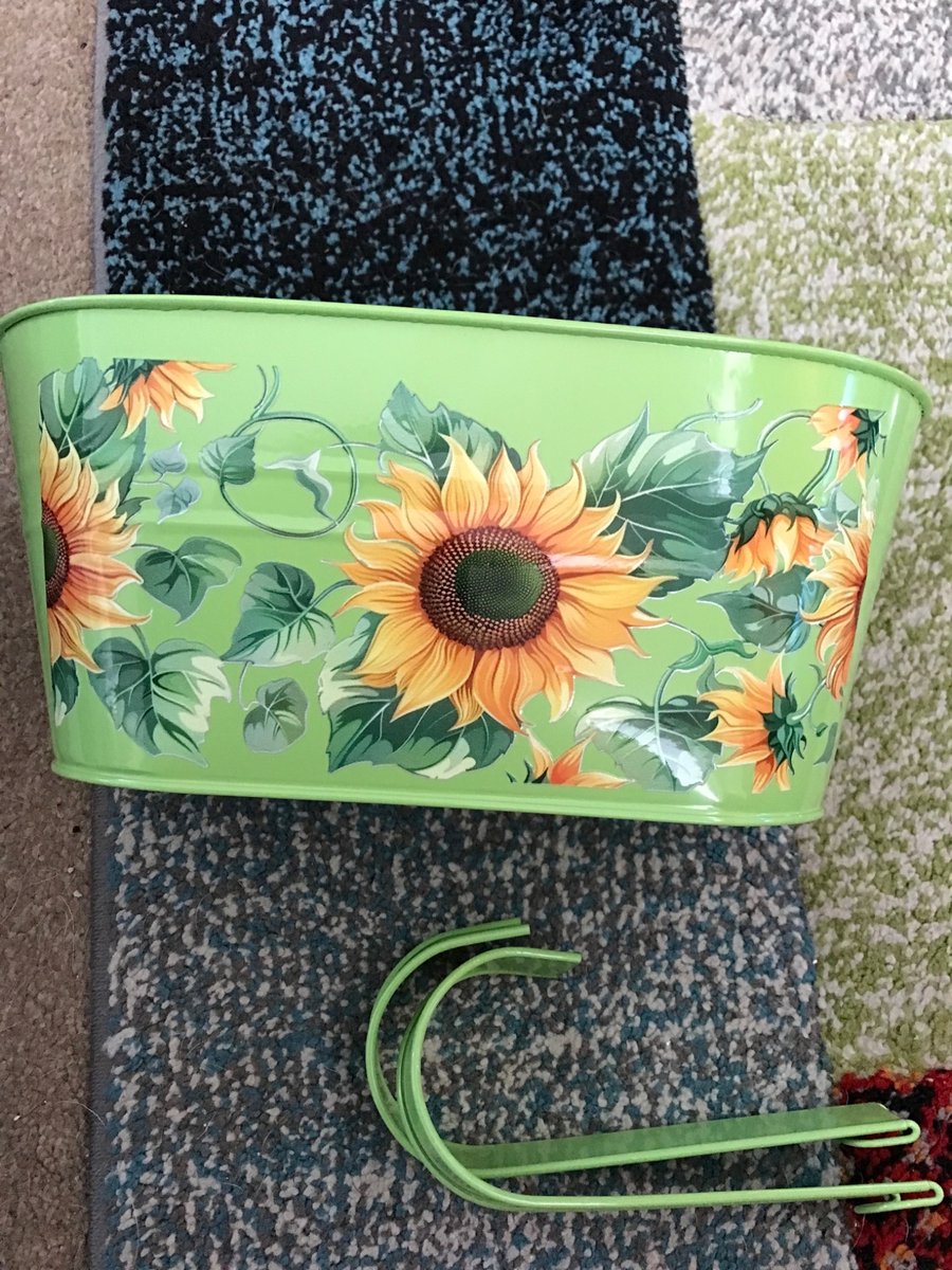 Green fence planter with stunning sunflowers motif