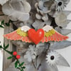Heart sculpture, red ceramic heart with wings in lime green and pink