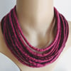 Felted cord necklace in shades of deep pink purple