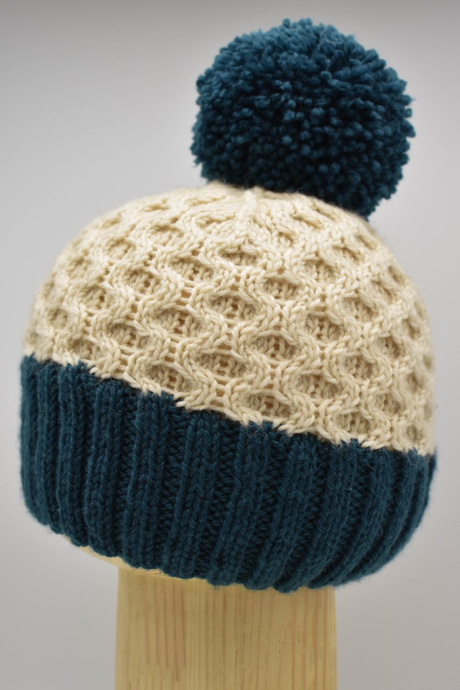 Hand Knitted "Honeycomb" Pom-pom hat in teal and cream