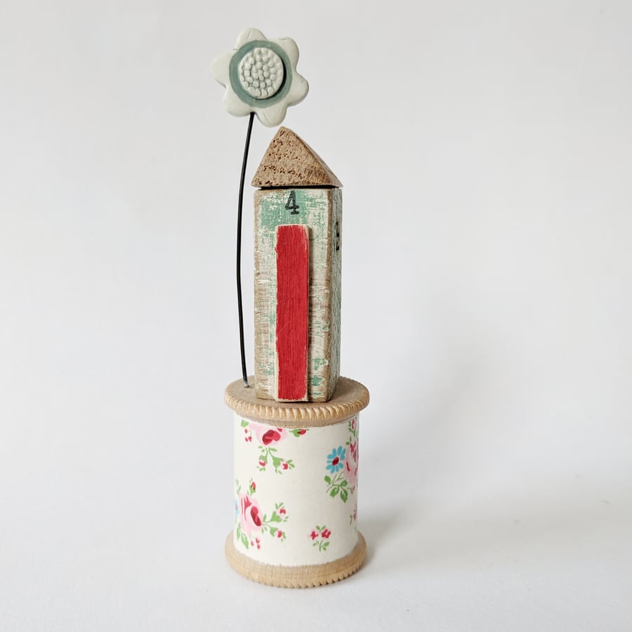 Rustic Wooden Shed on a Vintage Floral Bobbin with Clay Flower