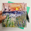 Sunrise on a misty morning across a hedgerow with the hills beyond printed card.