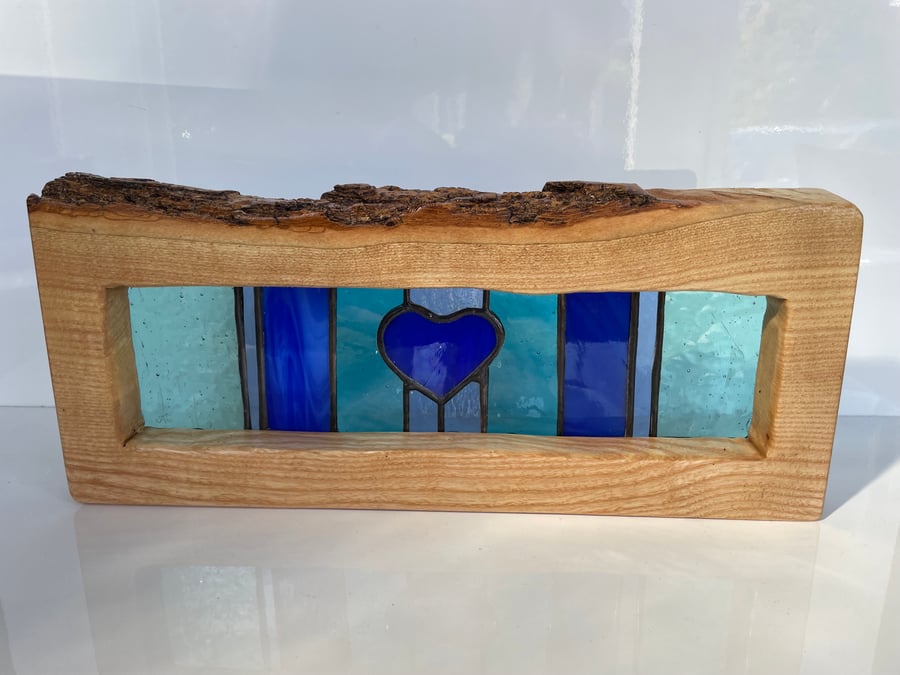 Blue Heart stained glass in solid ash frame with live edge feature