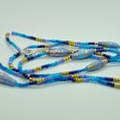 Long Summer Swirl Beaded Necklace in shades of blue with handmade paper beads