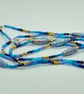 Long Summer Swirl Beaded Necklace in shades of blue with handmade paper beads - Image 1