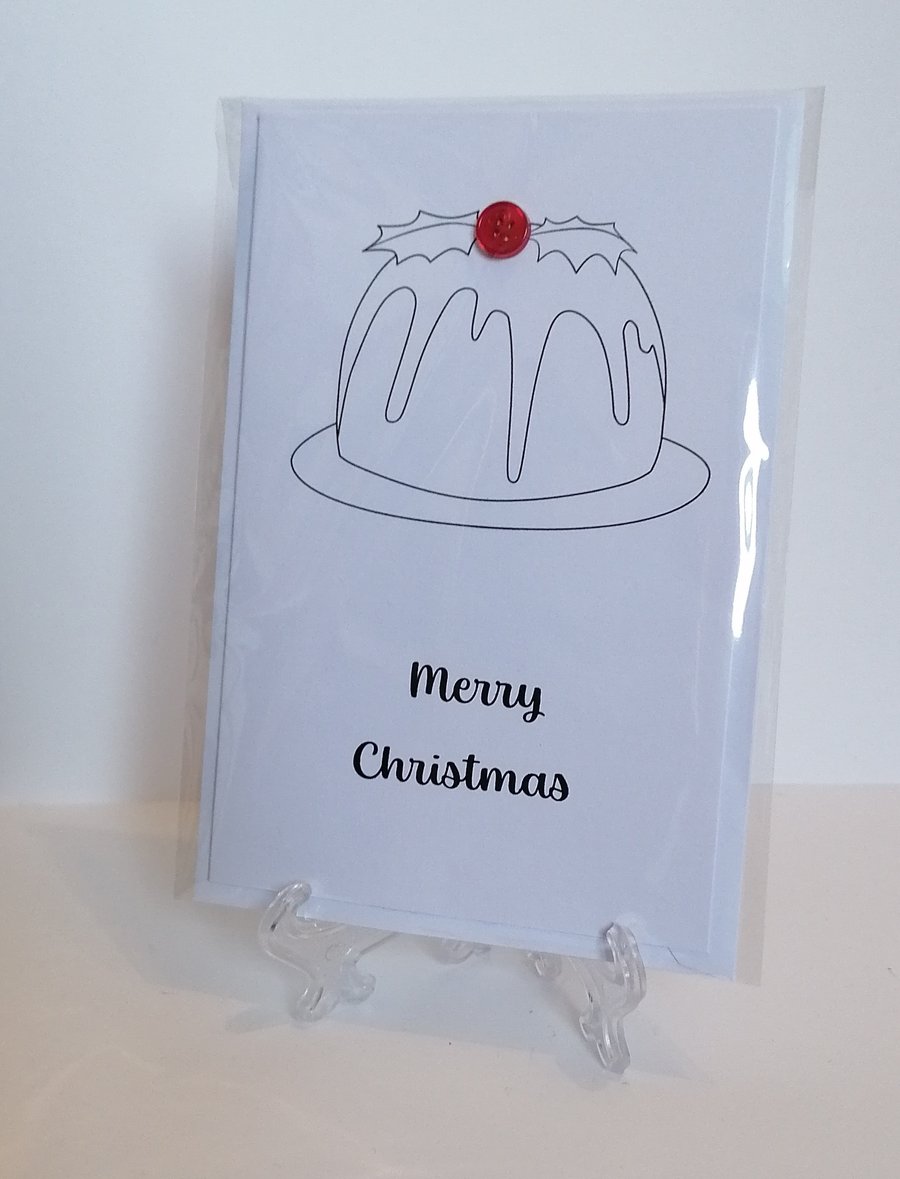 Merry Christmas card with a red button on the top of a Christmas pudding. 