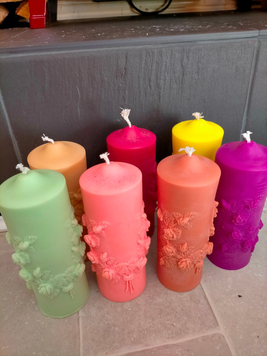 Pillar candle with engraved intricate design of flowers .