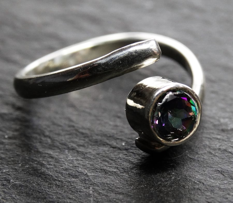 Sterling silver proud isolde ring.Twist,adjustable,resizeable. Mystic fire topaz