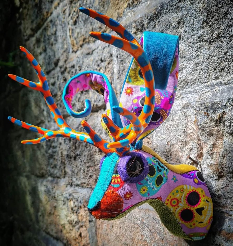Faux jackalope head wall mount in Day of the Dead skull style fabric
