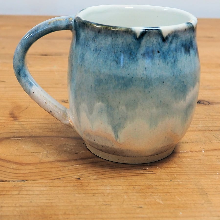 Pottery mug finished in multi-coloured blue and cream glaze, handmade