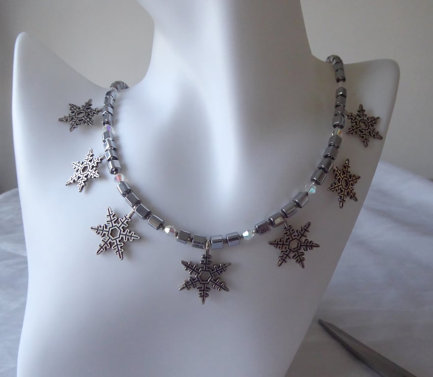 Cube and Faceted Bicone Beaded Necklace with Seven Dangling Metal Snowflakes  