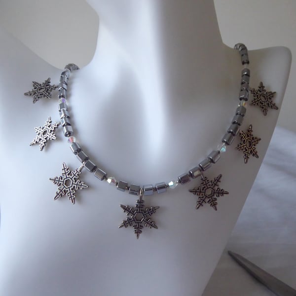 Cube and Faceted Bicone Beaded Necklace with Seven Dangling Metal Snowflakes  