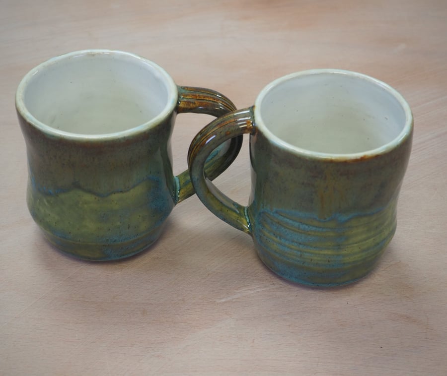  Stoneware pottery mug finished in a turquoise multicolour glaze