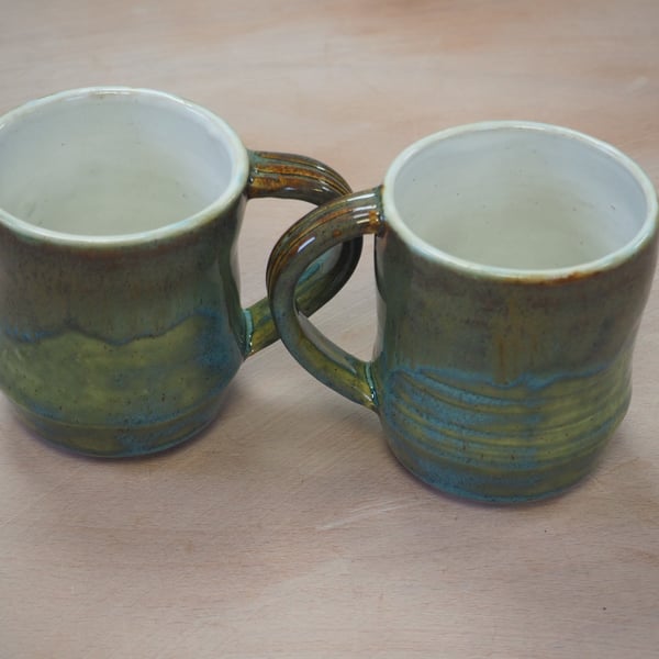  Stoneware pottery mug finished in a turquoise multicolour glaze