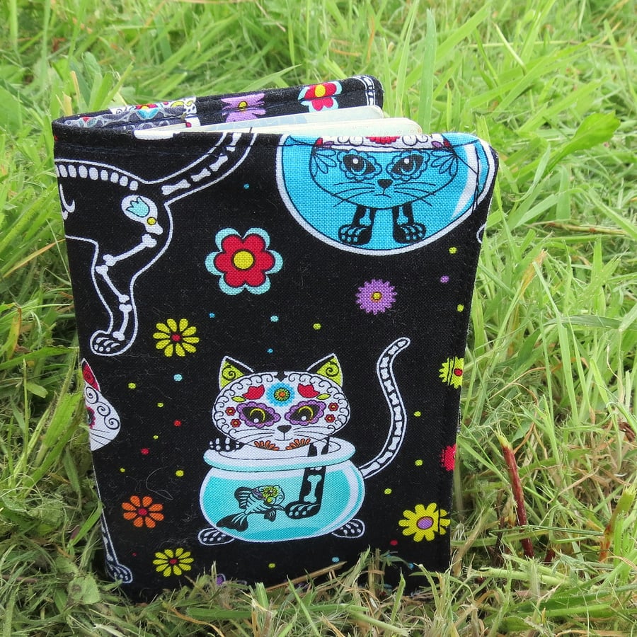 A passport sleeve with a scary cats design.  Passport cover.