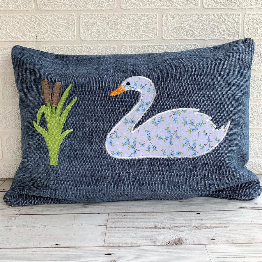 Blue rectangular cushion with swan and bulrushes