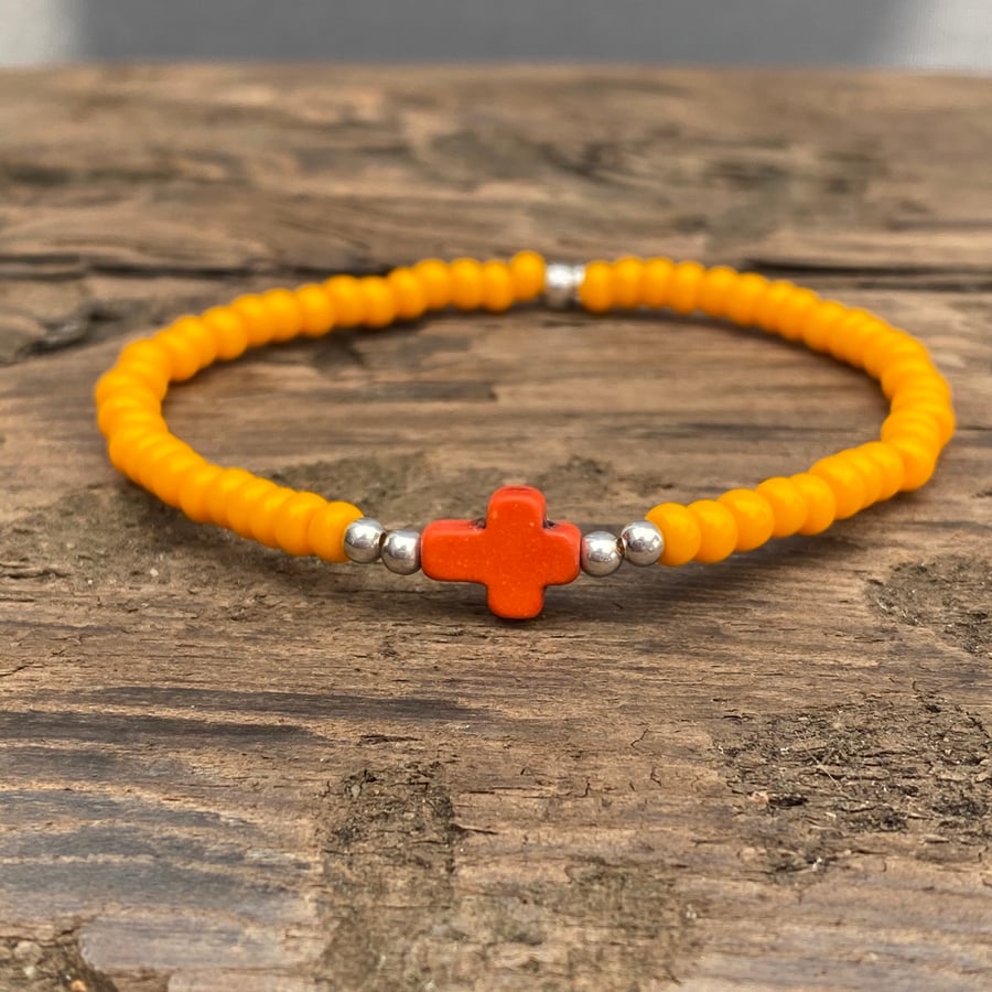 Orange howlite cross and orange seed bead bracelet 