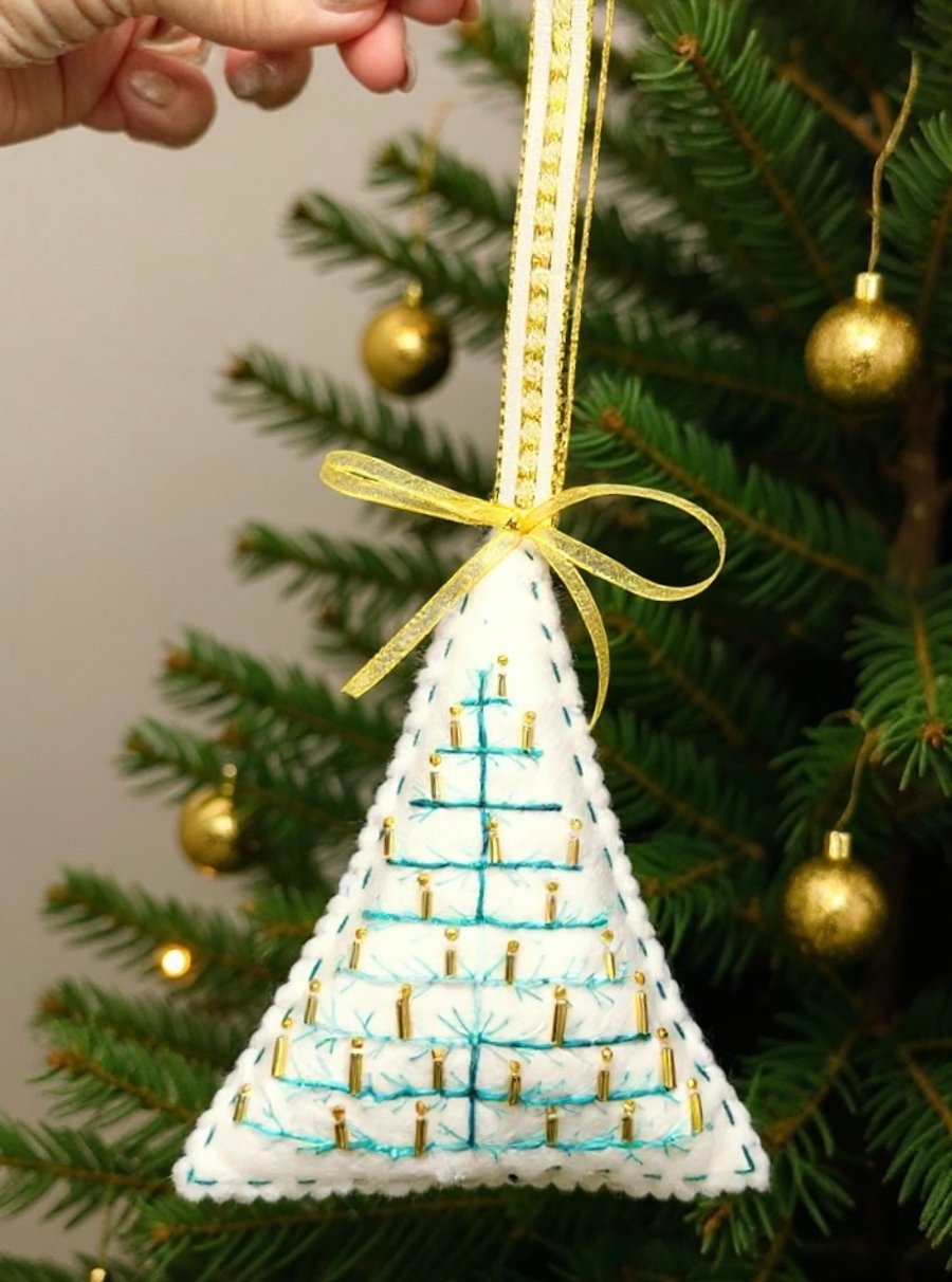 Felt hanging decoration of a large Christmas tree adorned with golden candles. 