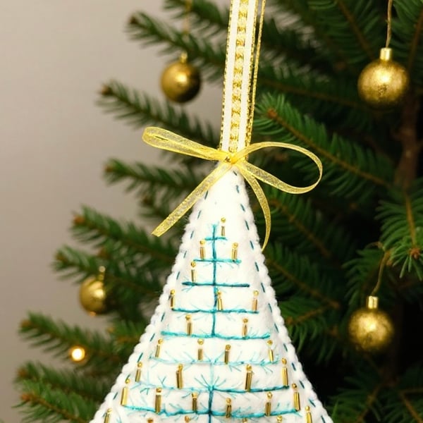 Felt hanging decoration of a large Christmas tree adorned with golden candles. 