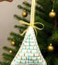 Felt hanging decoration of a large Christmas tree adorned with golden candles. 