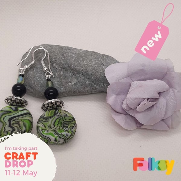 Polymer clay earrings in a green, silver, white and black swirl design